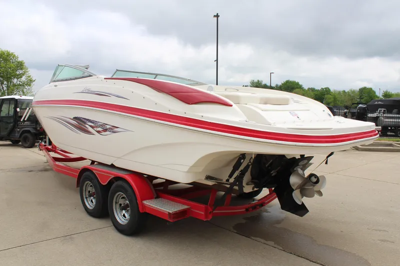Slide: The Image of 2007 Rinker 246 Captiva Bowrider on red trailer, parked outdoors. - 12