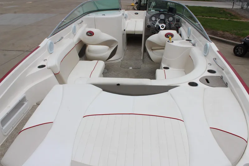 Slide: The Image of 2007 Rinker 246 Captiva Bowrider interior with white seating and dashboard view. - 15