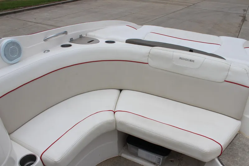 Slide: The Image of 2007 Rinker 246 Captiva Bowrider interior with white seating and red accents. - 18