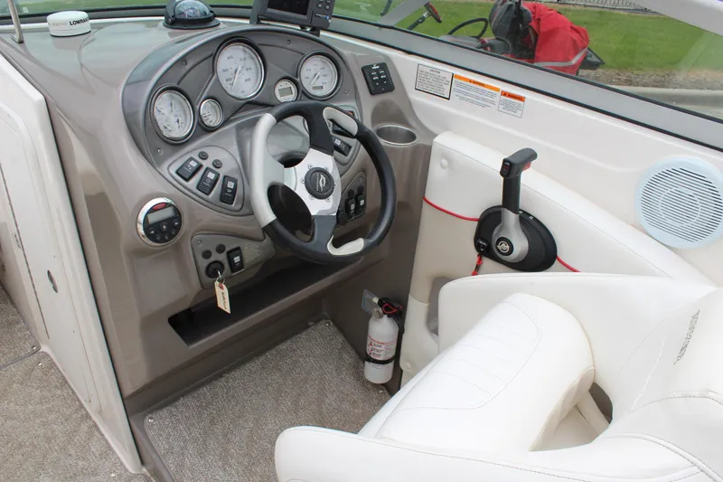 Slide: The Image of 2007 Rinker 246 Captiva Bowrider dashboard with steering wheel and control panel. - 19