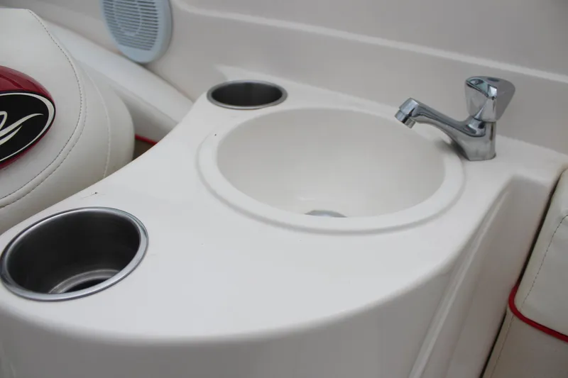 Slide: The Image of 2007 Rinker 246 Captiva Bowrider interior with sink and cup holders. - 20