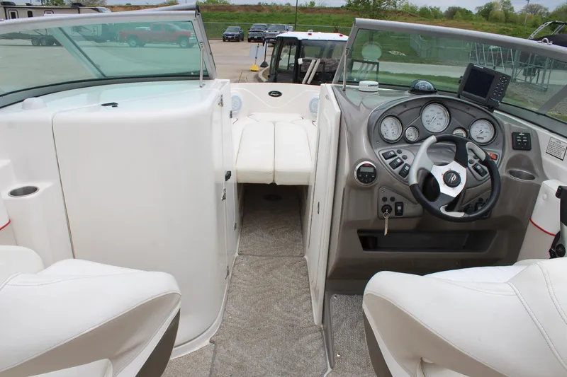 Slide: The Image of 2007 Rinker 246 Captiva Bowrider interior with steering wheel and dashboard controls. - 25