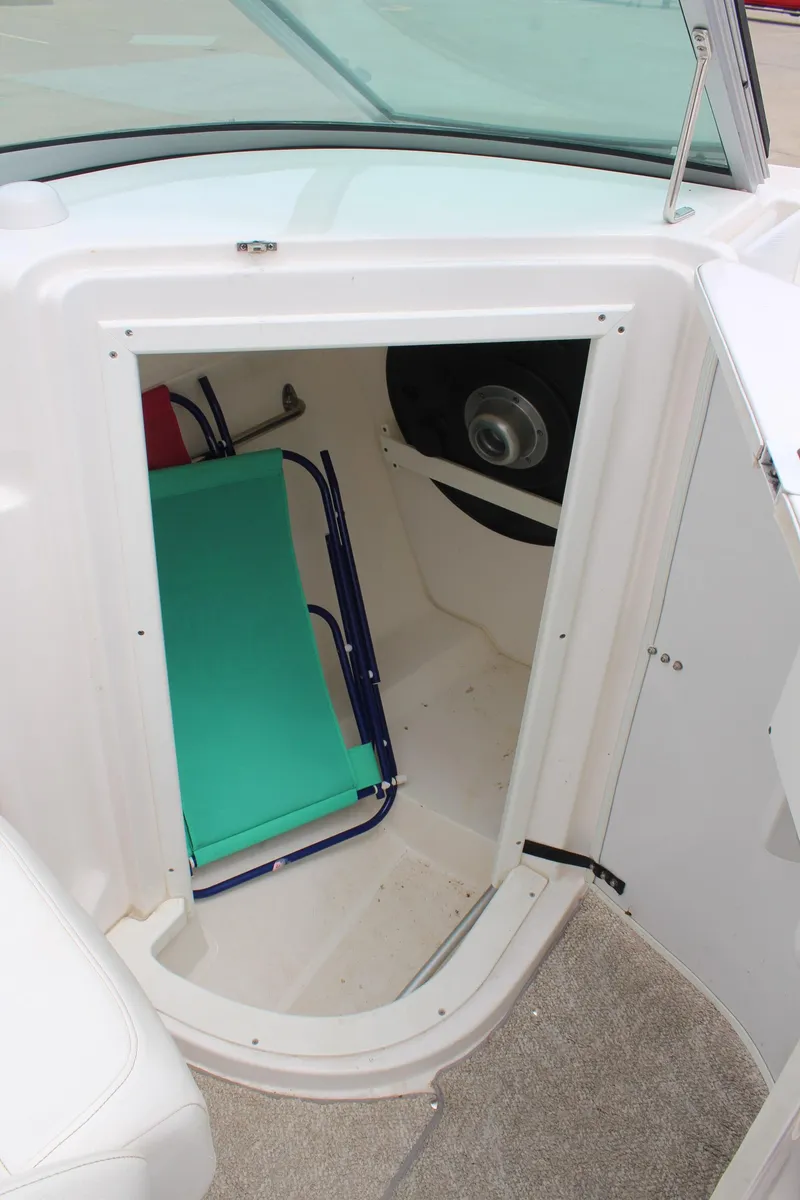 Slide: The Image of 2007 Rinker 246 Captiva Bowrider storage compartment with seating and speaker. - 28