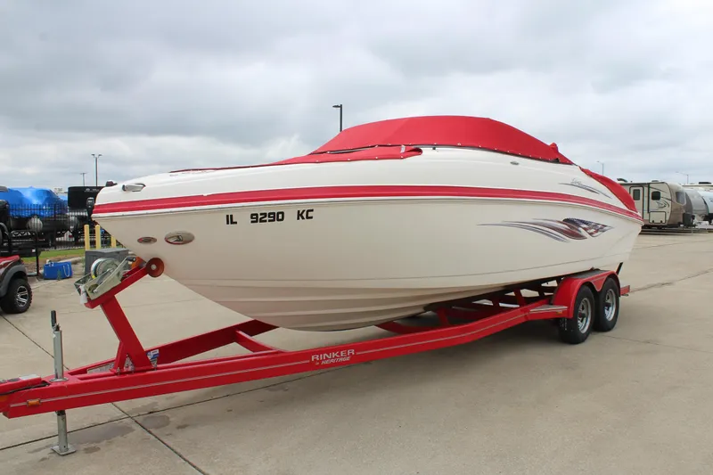 Slide: The Image of 2007 Rinker 246 Captiva Bowrider on red trailer, covered, parked outdoors. - 3