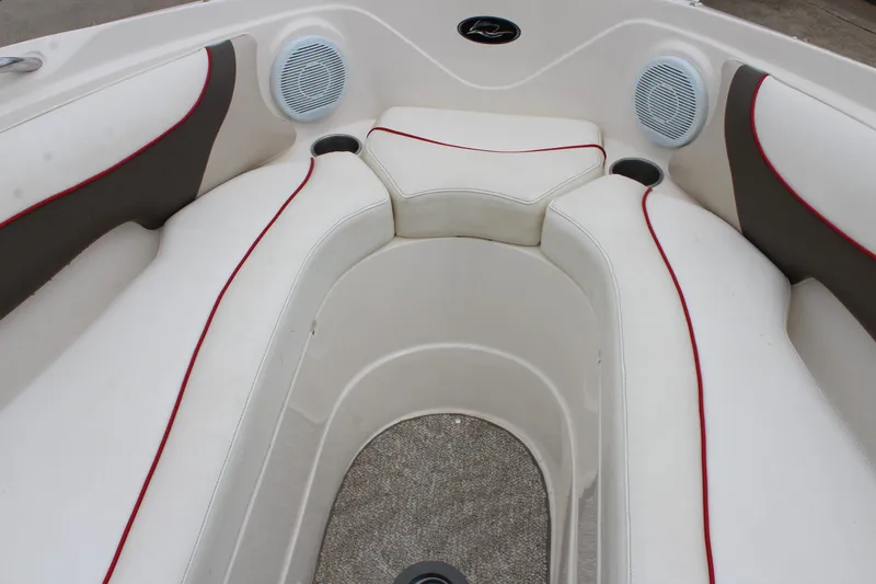 Slide: The Image of 2007 Rinker 246 Captiva Bowrider interior with white seating and red accents. - 31