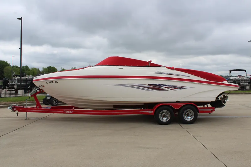 Slide: The Image of 2007 Rinker 246 Captiva Bowrider on red trailer, parked outdoors under cloudy sky. - 4