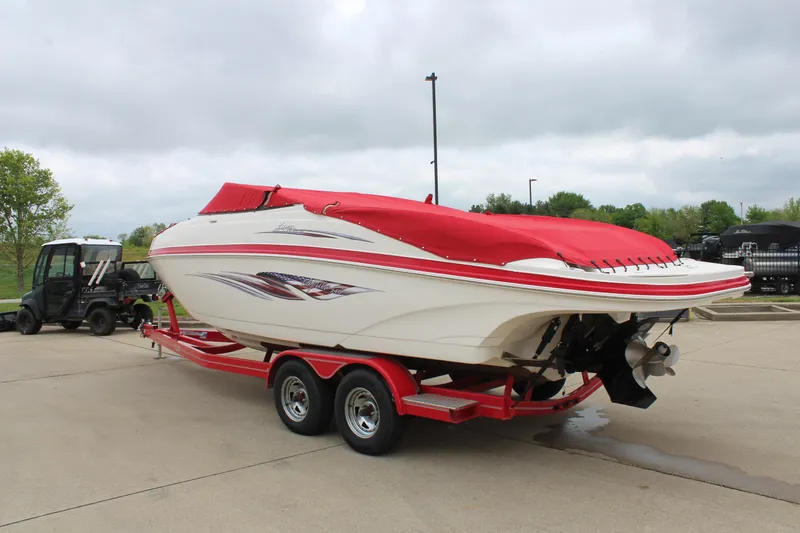 Slide: The Image of 2007 Rinker 246 Captiva Bowrider on red trailer, covered, parked outdoors. - 5