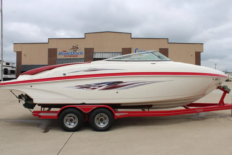 Slide: The Image of 2007 Rinker 246 Captiva Bowrider on red trailer, parked outside a dealership. - 7