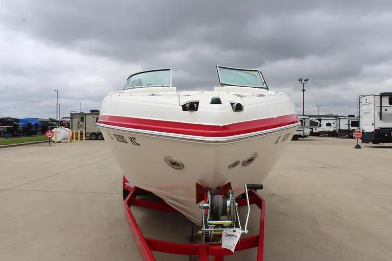 Slide: The Image of 2007 Rinker 246 Captiva Bowrider on trailer, parked outdoors under cloudy skies. - 9