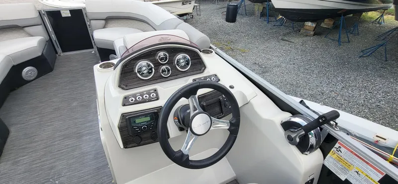 Slide: The Image of 2022 Lowe SS 210 boat dashboard with steering wheel and control panel. - 3