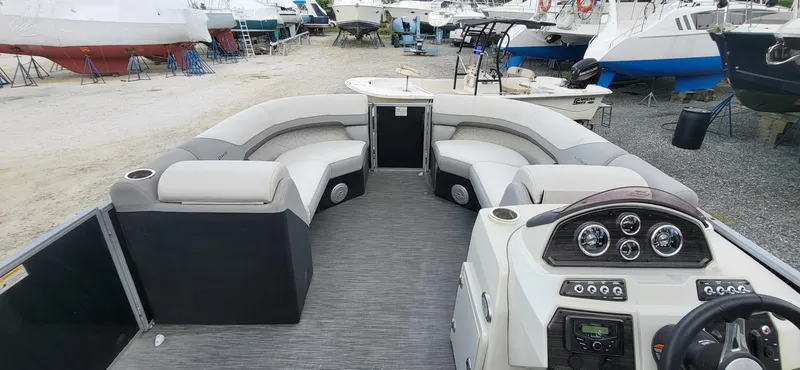 Slide: The Image of 2022 Lowe SS 210 pontoon boat interior with seating and control panel. - 5