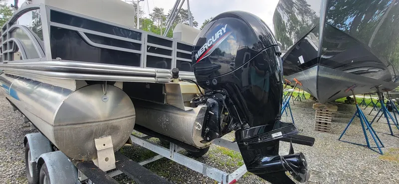 Slide: The Image of 2022 Lowe SS 210 pontoon boat with Mercury outboard motor on trailer. - 9