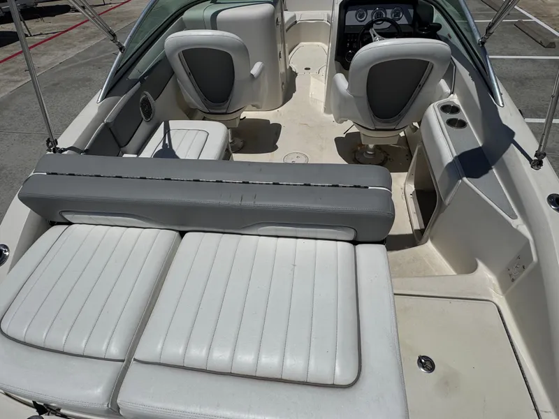 Slide: The Image of 2010 Sea Ray 220 Sundeck interior with white seating and dashboard view. - 15