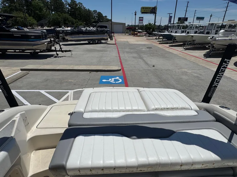 Slide: The Image of 2010 Sea Ray 220 Sundeck boat in a marina parking lot, near a handicap space. - 17