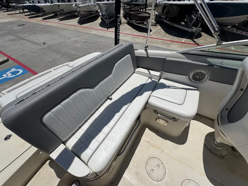 Slide: The Image of 2010 Sea Ray 220 Sundeck interior with gray seating and storage compartments. - 18