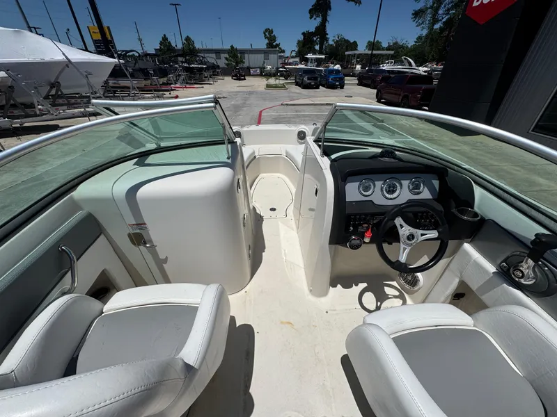 Slide: The Image of Interior view of 2010 Sea Ray 220 Sundeck boat, featuring steering wheel and seating. - 19