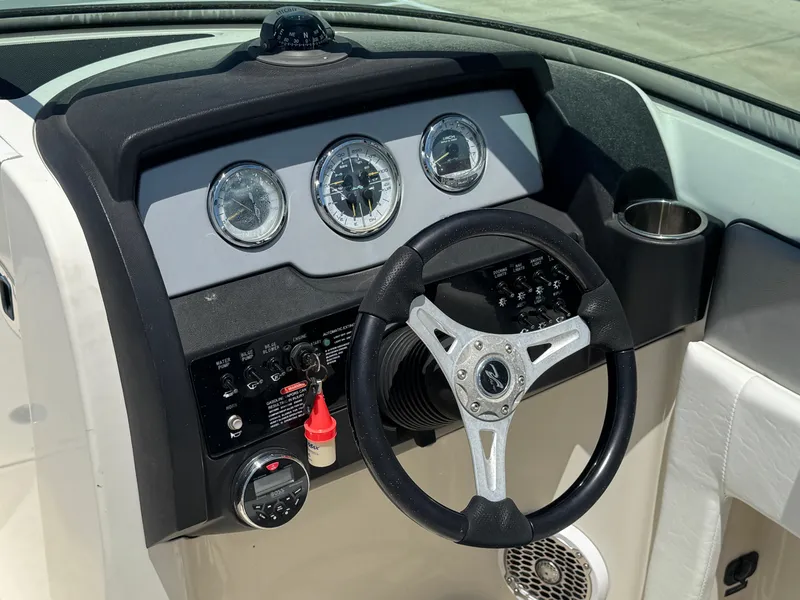 Slide: The Image of Steering console of 2010 Sea Ray 220 Sundeck boat with gauges and controls. - 20