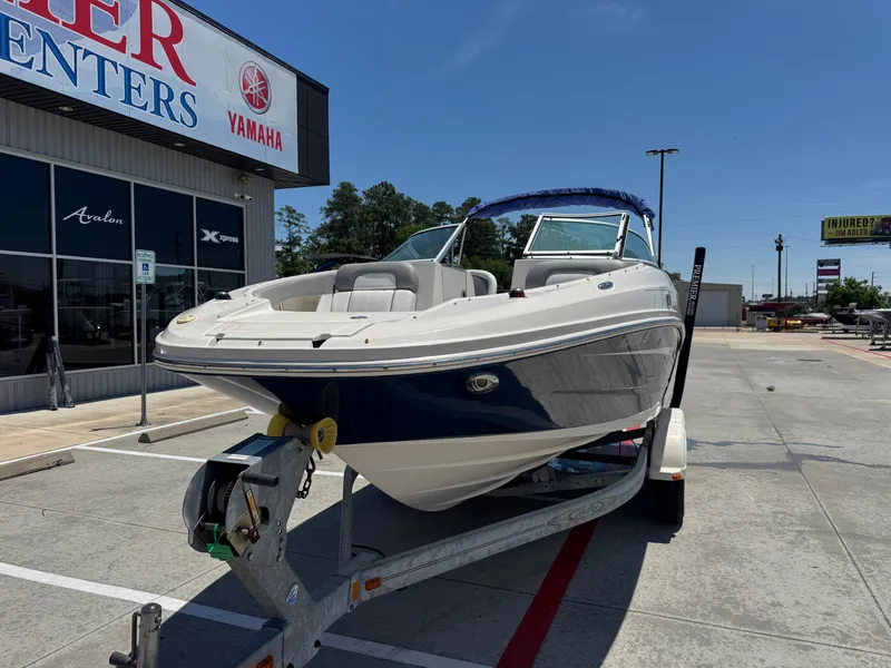 Slide: The Image of 2010 Sea Ray 220 Sundeck boat on trailer outside dealership. - 6