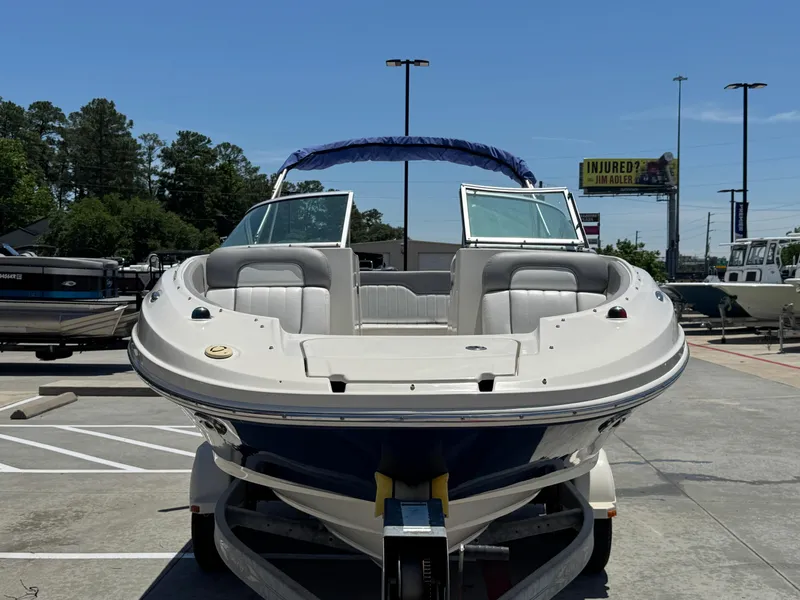 Slide: The Image of 2010 Sea Ray 220 Sundeck boat on trailer in parking lot, sunny day. - 7
