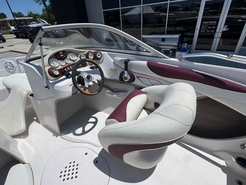 Slide: The Image of Interior of a 2015 TAHOE Q7I boat with steering wheel and dashboard controls. - 11