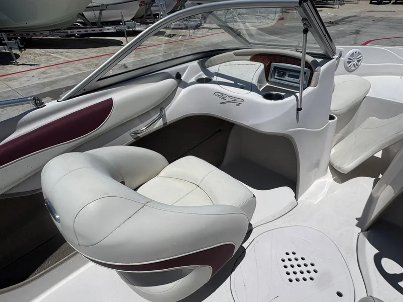Slide: The Image of Interior of a 2015 TAHOE Q7I boat with white and maroon seating. - 12