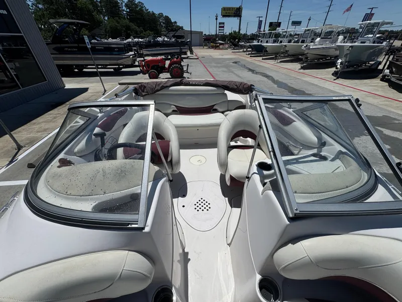 Slide: The Image of Interior view of a 2015 TAHOE - WRMG Q7I boat, featuring seating and windshield. - 15