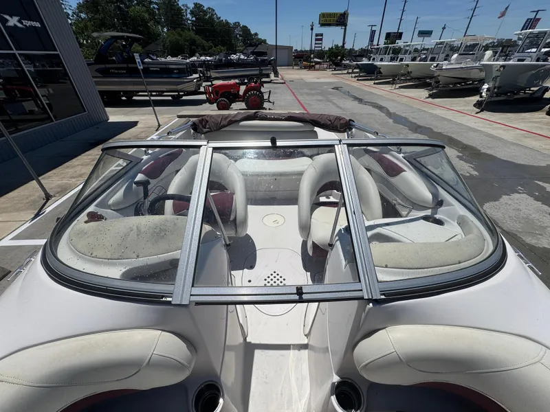 Slide: The Image of 2015 TAHOE WRMG Q7I boat with windshield, parked at a dealership. - 16