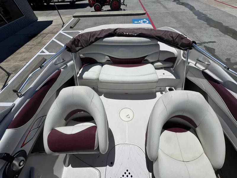Slide: The Image of Interior of a 2015 TAHOE - WRMG Q7I boat with white and maroon seating. - 17