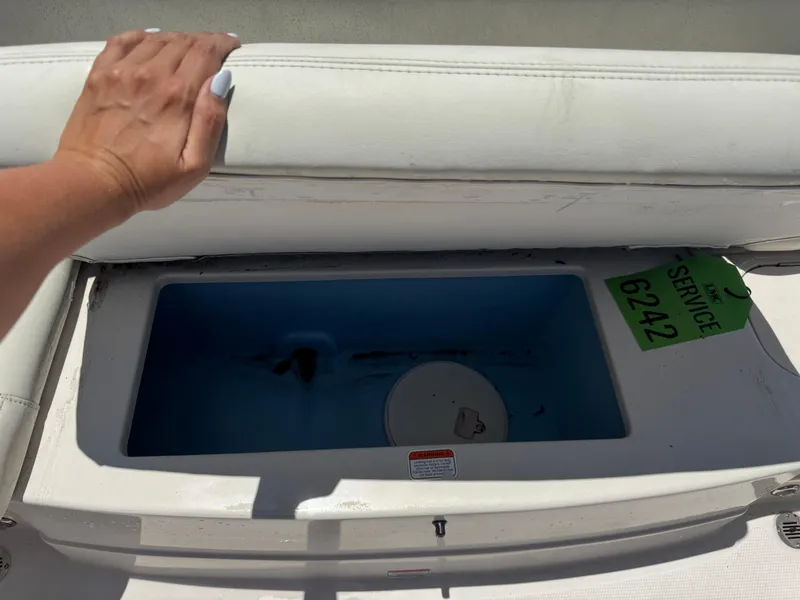 Slide: The Image of Open storage compartment on a 2015 TAHOE WRMG Q7I boat with service tag. - 20