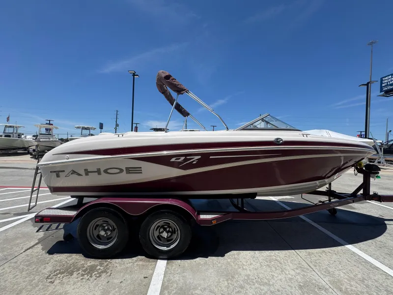 Slide: The Image of 2015 TAHOE Q7I boat on trailer under clear blue sky. - 27