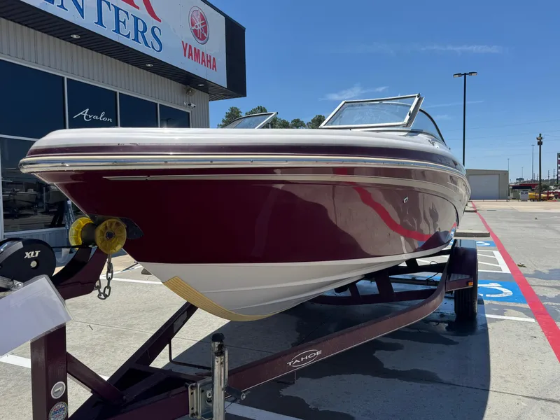Slide: The Image of 2015 TAHOE Q7I boat on trailer outside dealership, sunny day. - 6