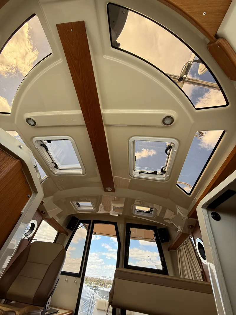 Slide: The Image of 2023 Ranger Tugs R-25 interior with panoramic windows and modern design. - 19