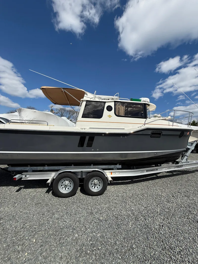 Slide: The Image of 2023 Ranger Tugs R-25 boat on trailer under blue sky. - 5