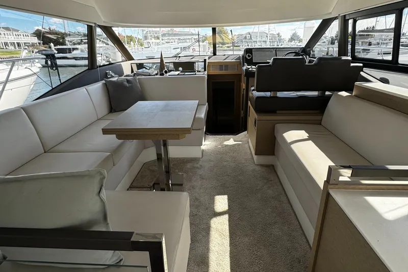Slide: The Image of Interior of 2019 Prestige 460 Fly Bridge yacht with spacious seating and modern design. - 10