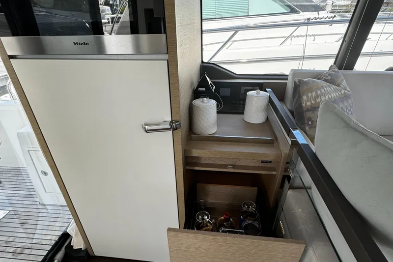 Slide: The Image of Interior of 2019 Prestige 460 Fly Bridge yacht with Miele fridge and storage area. - 12