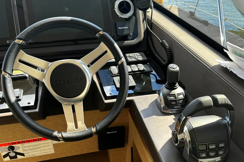 Slide: The Image of Helm of 2019 Prestige 460 Fly Bridge yacht with steering wheel and controls. - 18