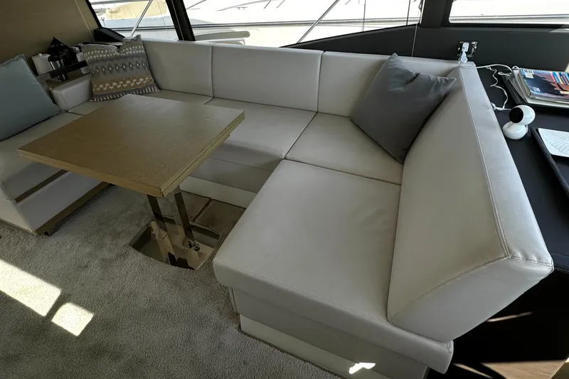 Slide: The Image of Luxurious seating area on 2019 Prestige 460 Fly Bridge yacht with elegant table. - 21