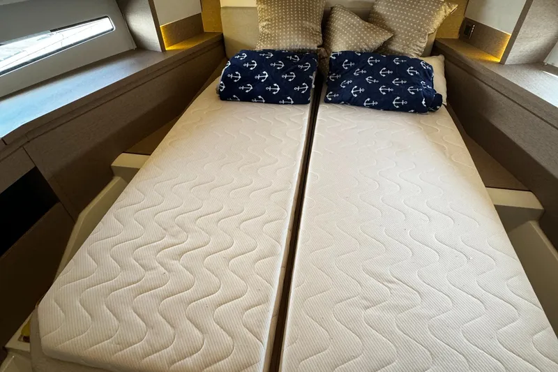 Slide: The Image of Twin beds in a 2019 Prestige 460 Fly Bridge yacht cabin with nautical-themed pillows. - 23