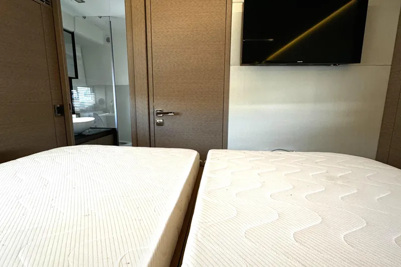 Slide: The Image of Interior of 2019 Prestige 460 Fly Bridge yacht with twin beds and TV. - 24