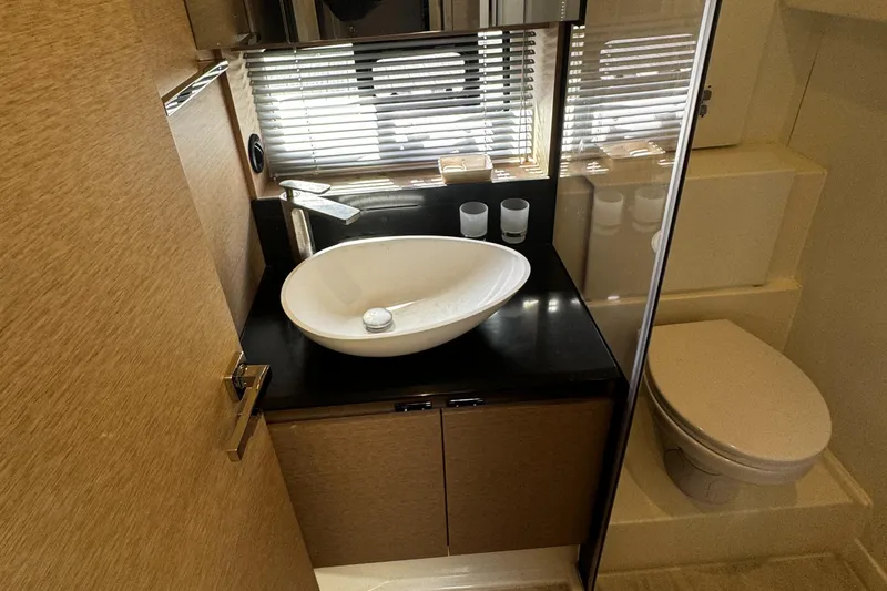Slide: The Image of Luxurious bathroom in 2019 Prestige 460 Fly Bridge yacht with modern sink and toilet. - 26