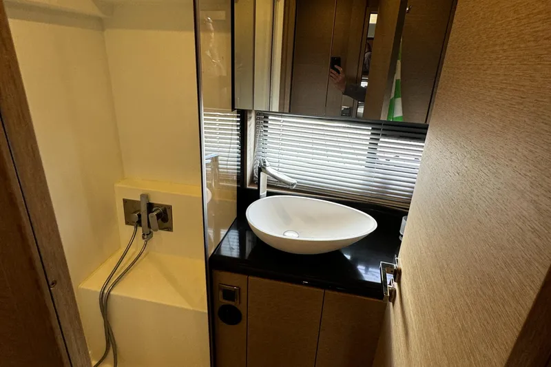 Slide: The Image of Modern bathroom in 2019 Prestige 460 Fly Bridge yacht with sleek sink and shower. - 28