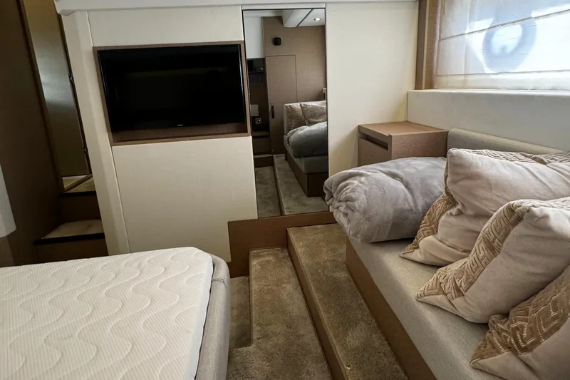 Slide: The Image of Luxurious interior of 2019 Prestige 460 Fly Bridge yacht with cozy bedding and modern decor. - 34