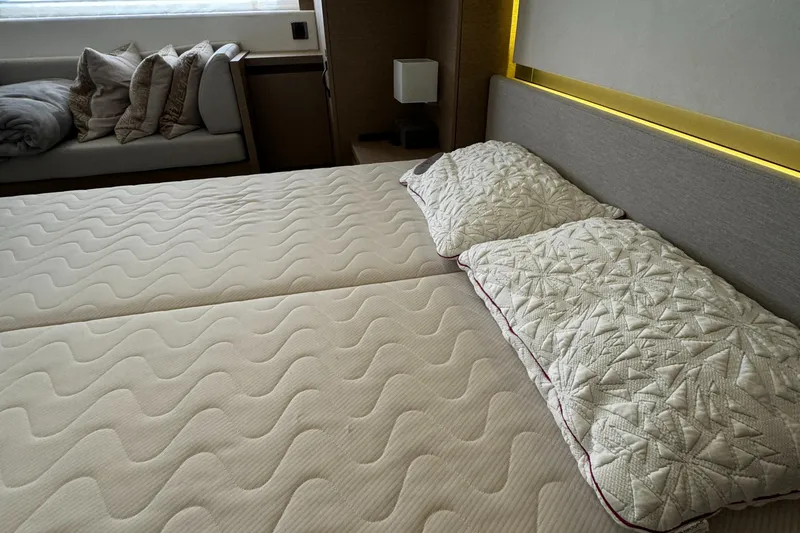 Slide: The Image of Luxurious bedroom interior on 2019 Prestige 460 Fly Bridge yacht, featuring elegant bedding. - 37