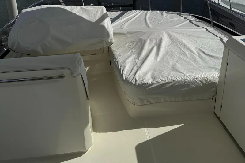 Slide: The Image of 2019 Prestige 460 Fly Bridge yacht deck with covered seating area. - 41