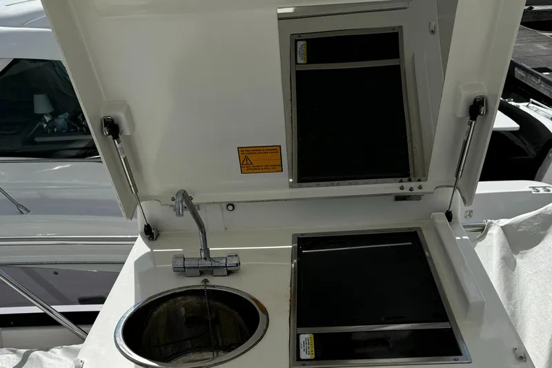 Slide: The Image of Outdoor kitchenette on 2019 Prestige 460 Fly Bridge yacht with sink and storage. - 44