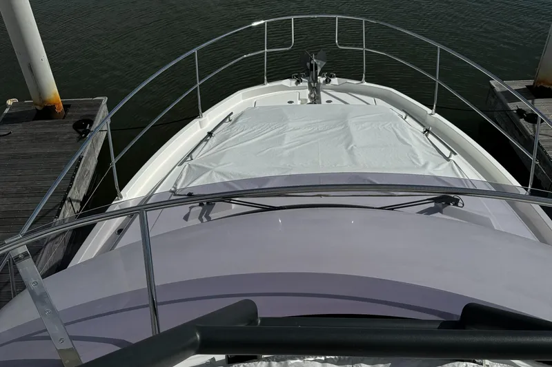 Slide: The Image of 2019 Prestige 460 Fly Bridge yacht docked, view from the bow. - 46