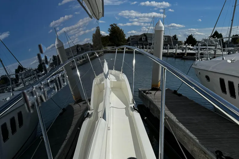 Slide: The Image of 2019 Prestige 460 Fly Bridge yacht docked at marina under blue sky. - 9