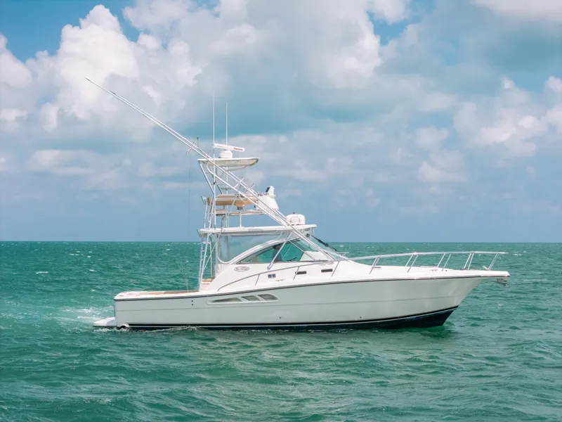 Slide: The Image of 2007 Rampage 38 Express yacht cruising on open sea under cloudy sky. - 0