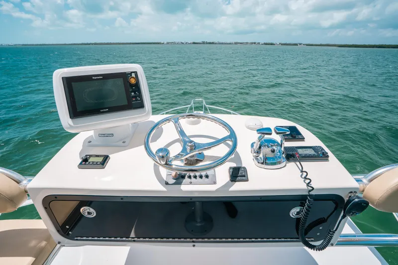 Slide: The Image of Helm of 2007 Rampage 38 Express boat with navigation equipment on open water. - 12