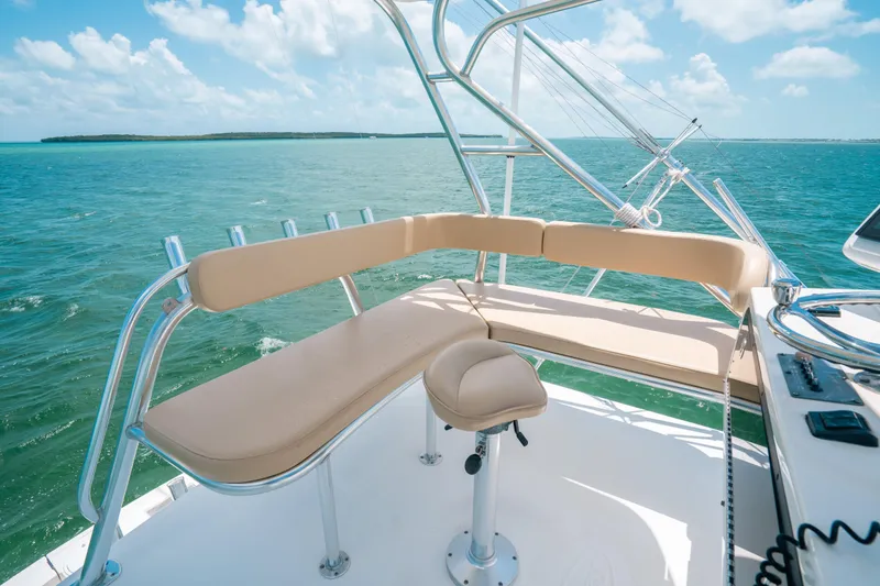 Slide: The Image of 2007 Rampage 38 Express boat with beige seating, overlooking clear blue ocean waters. - 14